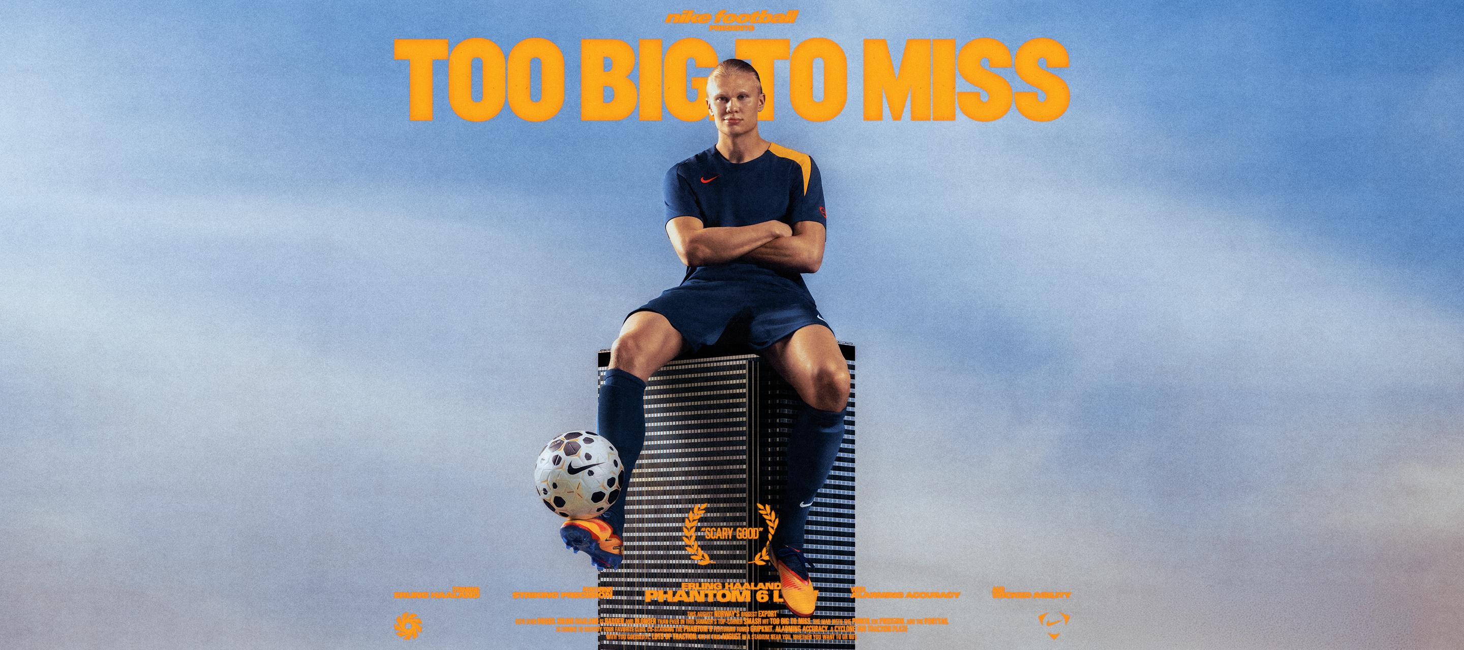 Erling Haaland sitting on top of a buildling balancing a football on his foot.