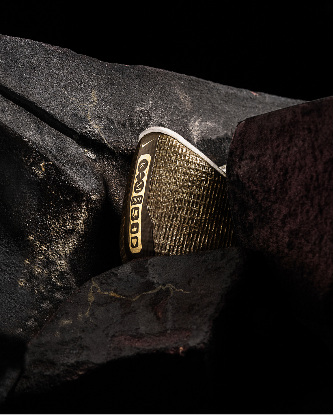 Graphics on the heel of Kylian's boot is revealed through the dark stoned mold.