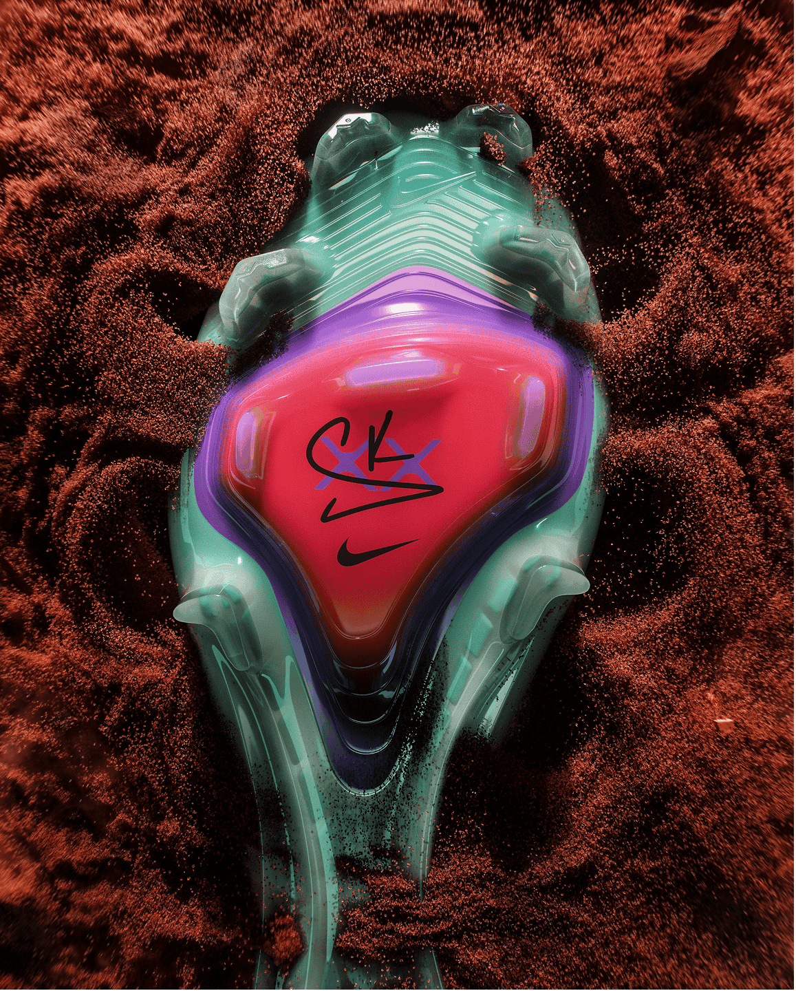 Bottom of Sam's football boot with her signature in the center. Sand exploding behind and around the boot.